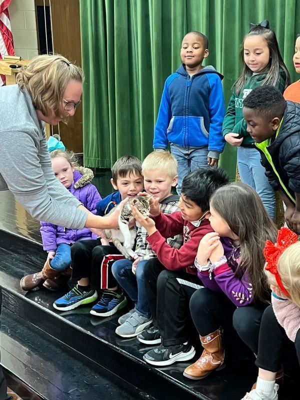 childeren petting cat