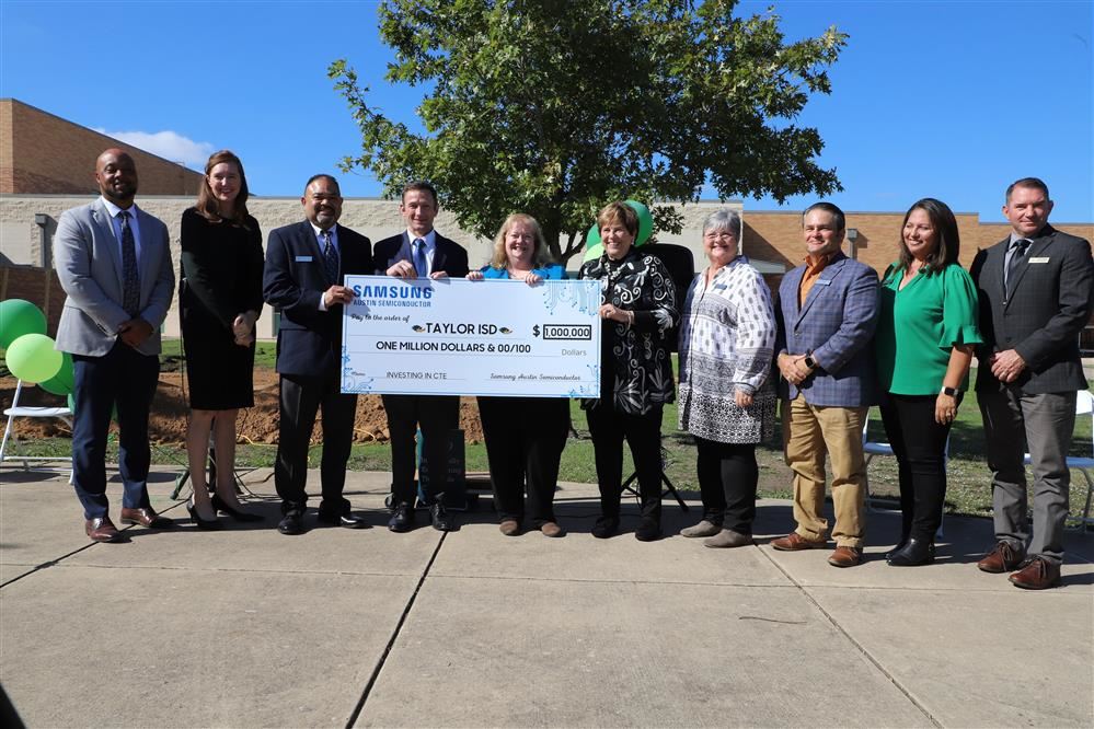  District and Samsung Officials with $1 million check. 