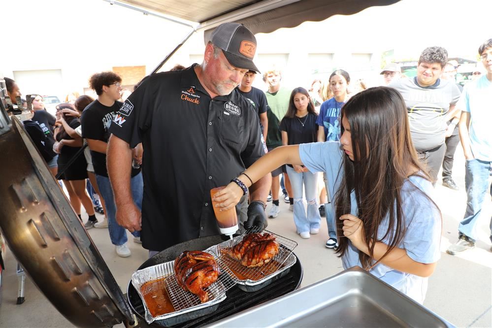  Student adding sauce to BBQ chicken