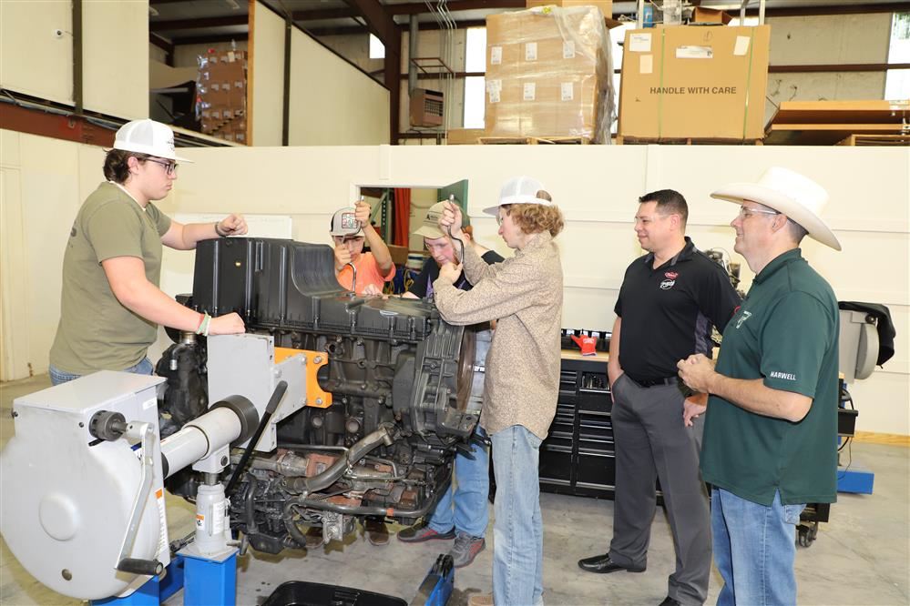  Students working on diesel motor.
