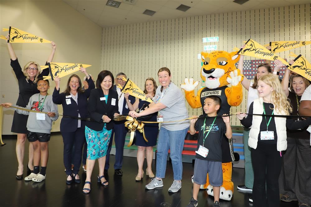 Group on stage cutting ribbon